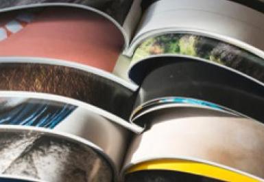 colorful magazines open, stacked on top of one another.
