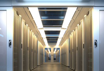 A warmly lit data center extends down a long hallway